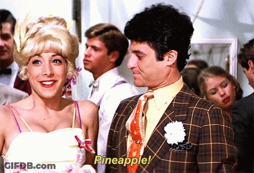 A Man And A Woman Are Standing Next To Each Other With Pineapple Written On The Screen GIF