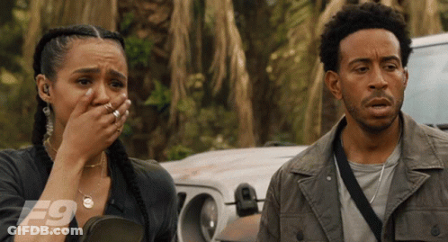 A Man And A Woman Are Standing Next To Each Other With The F9 Logo On The Bottom Right GIF