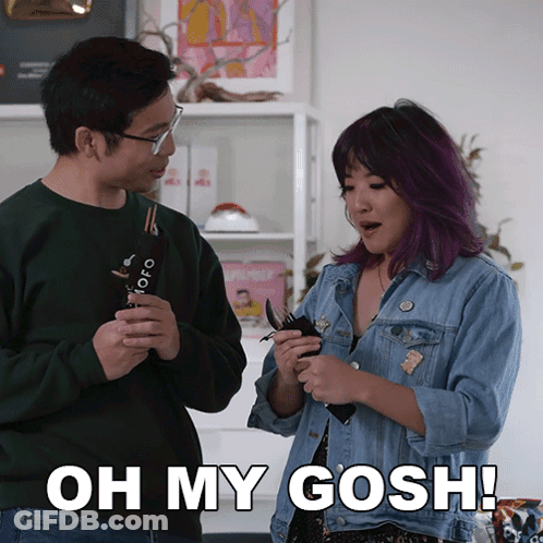 A Man And A Woman Are Standing Next To Each Other With The Woman Saying Oh My Gosh GIF