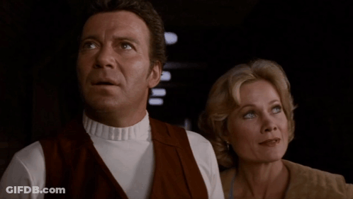 A Man And A Woman Are Standing Next To Each Other With The Words Can I Cook Or Can 'T I GIF