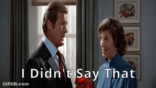 A Man And A Woman Are Standing Next To Each Other With The Words I Did N't Say That Written Above Them GIF