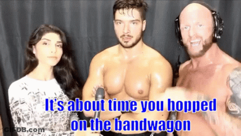 A Man And A Woman Are Standing Next To Each Other With The Words It 'S About Time You Hopped On The Bandwagon GIF