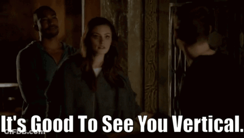 A Man And A Woman Are Standing Next To Each Other With The Words It 'S Good To See You Vertical GIF