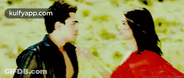 A Man And A Woman Are Standing Next To Each Other With The Words Kulfyapp.com On The Bottom Right GIF