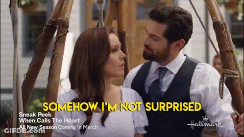 A Man And A Woman Are Standing Next To Each Other With The Words Somehow I 'M Not Surprised Behind Them GIF
