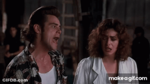A Man And A Woman Are Standing Next To Each Other With Their Mouths Open GIF