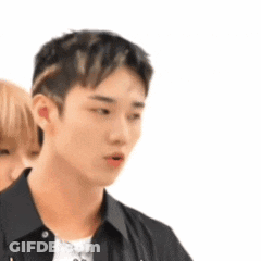 A Man And A Woman Are Standing Next To Each Other . GIF