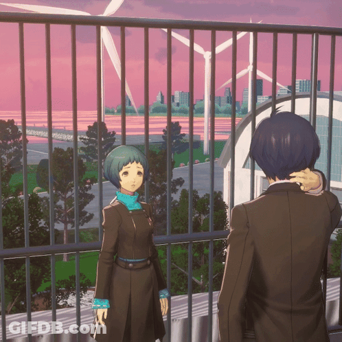 A Man And A Woman Are Standing On A Balcony Looking Out At A City GIF
