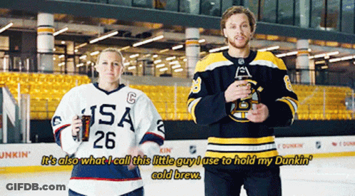 A Man And A Woman Are Standing On A Ice Rink And The Man Is Wearing A Usa Jersey GIF