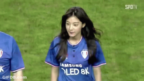 A Man And A Woman Are Standing On A Soccer Field . The Woman Is Wearing A Samsung Qled 8K Shirt . GIF