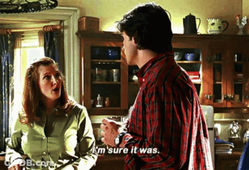 A Man And A Woman Are Talking In A Kitchen And The Man Is Saying `` I 'M Sure It Was . '' GIF