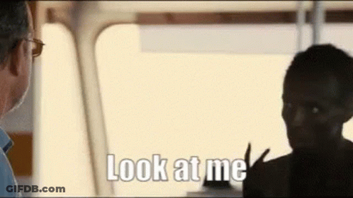 A Man And A Woman Are Talking To Each Other And The Man Is Saying Look At Me . GIF