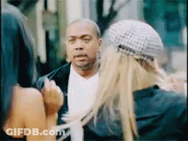A Man And A Woman Are Talking To Each Other In A Blurry Photo GIF