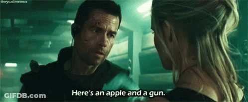 A Man And A Woman Are Talking To Each Other In A Dark Room . GIF