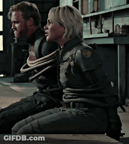 A Man And A Woman Are Tied Up With Ropes In A Room GIF