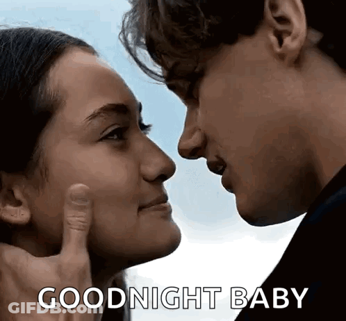 A Man And A Woman Are Touching Each Other 'S Faces . GIF