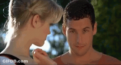 A Man And A Woman Are Touching Each Other 'S Faces In A Movie . GIF
