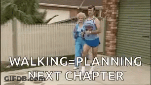 A Man And A Woman Are Walking Down A Sidewalk Next To Each Other . GIF