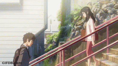 A Man And A Woman Are Walking Down Stairs GIF