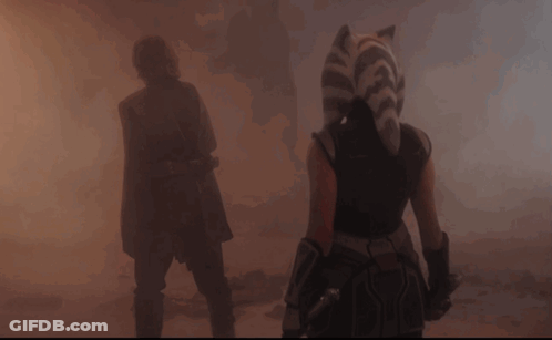 A Man And A Woman Are Walking Through A Foggy Area GIF