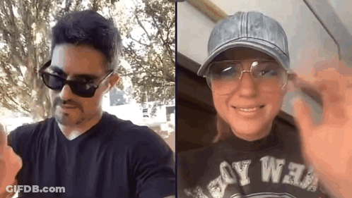 A Man And A Woman Are Wearing Sunglasses And A Hat . GIF
