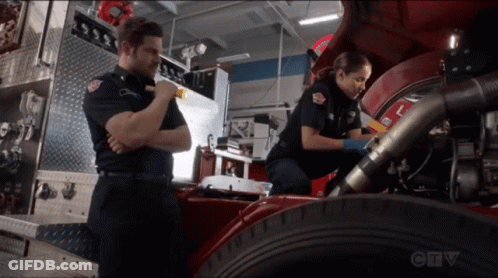 A Man And A Woman Are Working On A Fire Truck With A Ctv Logo In The Background GIF