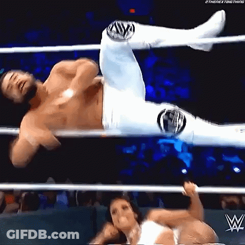 A Man And A Woman Are Wrestling In A Wrestling Ring . The Woman Is Holding The Man 'S Leg . GIF