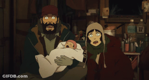 A Man And A Woman Holding A Baby In A Dark Room GIF