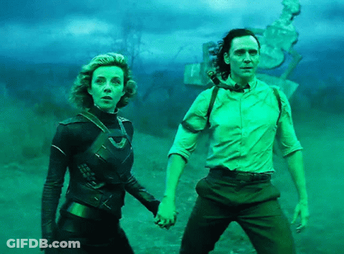 A Man And A Woman Holding Hands In A Field GIF