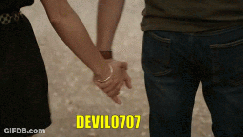 A Man And A Woman Holding Hands With The Devil0707 Written In Yellow GIF