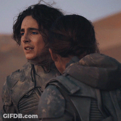 A Man And A Woman Hugging Each Other With The Man Holding The Woman 'S Head GIF