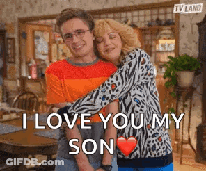 A Man And A Woman Hugging Each Other With The Words `` I Love You My Son '' Written On The Bottom . GIF
