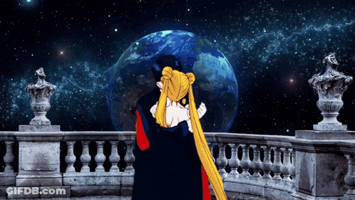 A Man And A Woman Hugging In Front Of A Statue Of The Earth GIF