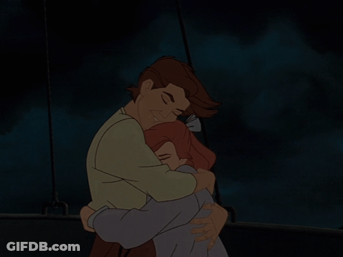 A Man And A Woman Hugging In The Dark GIF