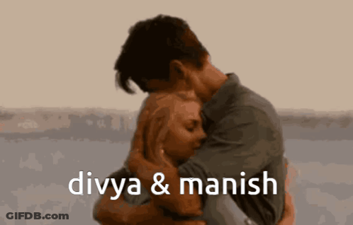 A Man And A Woman Hugging With The Words Divya & Manish Below Them GIF