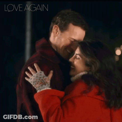 A Man And A Woman Hugging With The Words Love Again Behind Them GIF