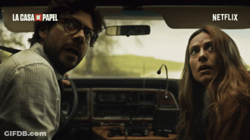 A Man And A Woman In A Car With La Casa De Papel Written On The Top GIF