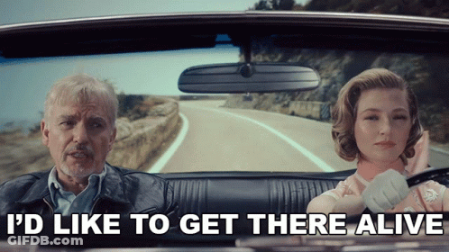 A Man And A Woman In A Car With The Words I 'D Like To Get There Alive Above Them GIF
