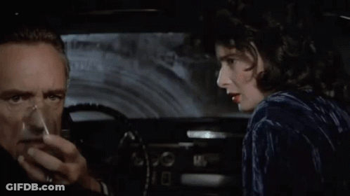 A Man And A Woman In A Car With The Words " Stay Alive Baby " Above Them GIF