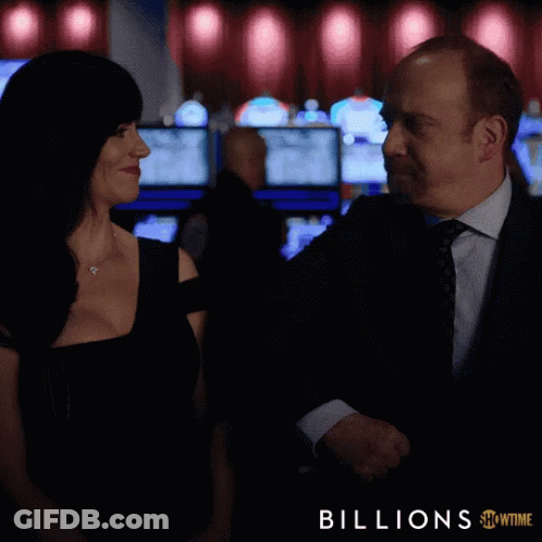 A Man And A Woman In A Casino With The Words Let 'S Go Act Like Winners Below Them GIF