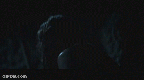 A Man And A Woman In A Dark Room GIF