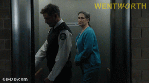 A Man And A Woman In An Elevator With The Word Wentworth On The Top GIF