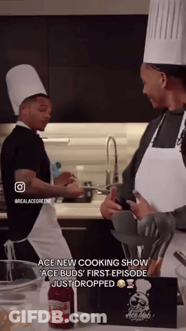 A Man And A Woman In Chef Hats Are Cooking In A Kitchen .. GIF