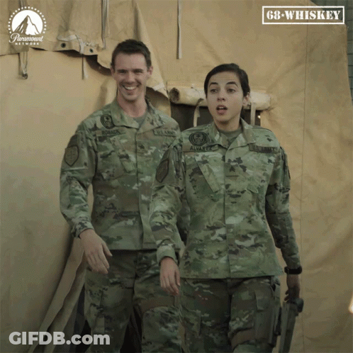 Man And Woman In Military Uniforms In Front Of GB Whiskey Sign GIF