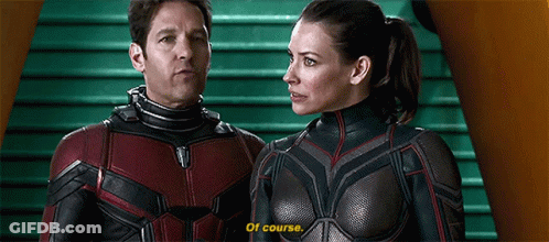 Man And Woman In Superhero Costumes On Green Staircase GIF