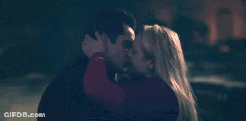 A Man And A Woman Kissing In The Dark GIF