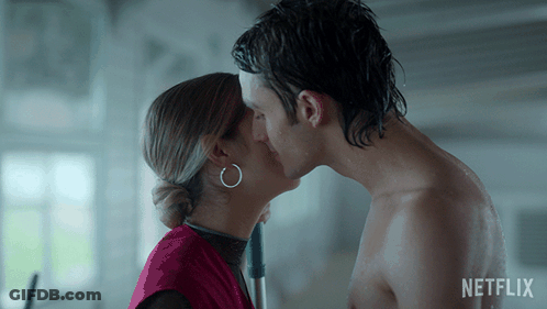 A Man And A Woman Kissing With A Netflix Logo In The Background GIF