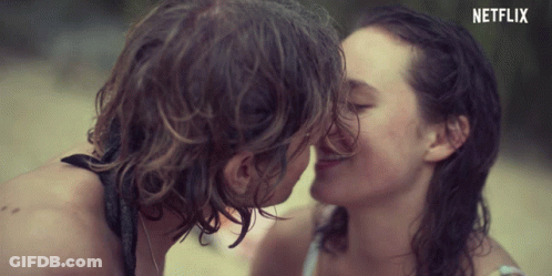 A Man And A Woman Kissing With A Netflix Logo In The Background GIF