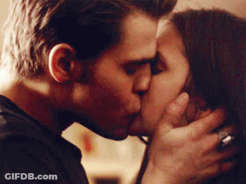 A Man And A Woman Kissing With The Man Wearing A Ring On His Finger GIF