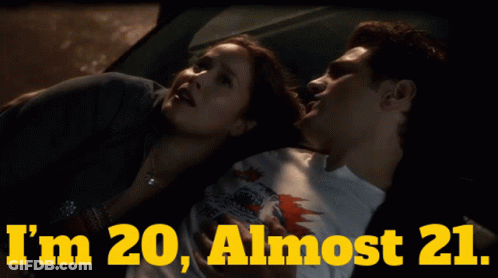 A Man And A Woman Laying In A Car With The Words " I 'M 20 Almost 21 " GIF